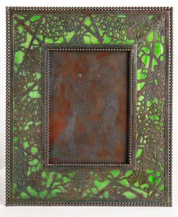 Tiffany Studios, New York, Picture Frame: Tiffany Studios, New York, Picture Frame Grapevine pattern. Favrile glass and bronze with greenish-brown patina. Impressed 'TIFFANY STUDIOS NEW YORK 947'. Ht. 9 1/2 W 8 in.