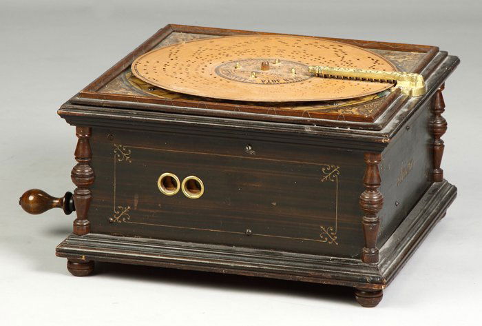 Unusual Josef Leopold 'Artisan' Disc Roller Organ: Original grain painted case & lithographed top. (21) paperboard records. 13" disc. Dr. Richard Pope Ht. 9" W 16" D 16"