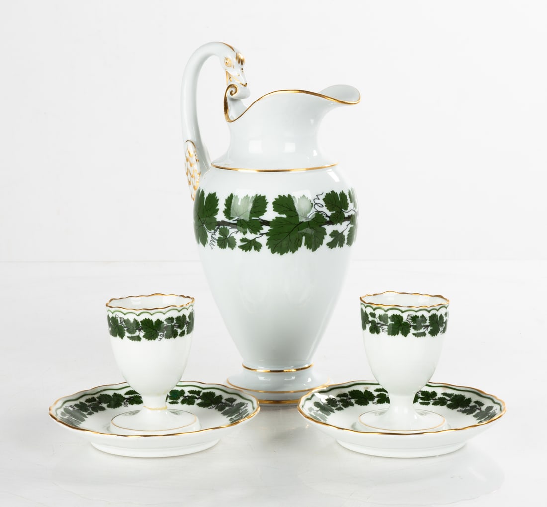 Meissen Porcelain Green Vine Pattern Ewer & Egg Cups: Meissen Porcelain Green Vine Pattern Ewer & Egg CupsCirca 1900. Including ewer and two egg cups with fixed stands.Max Ht. 8 in. ProvenanceEstate of James Prise, East Aurora, New York.