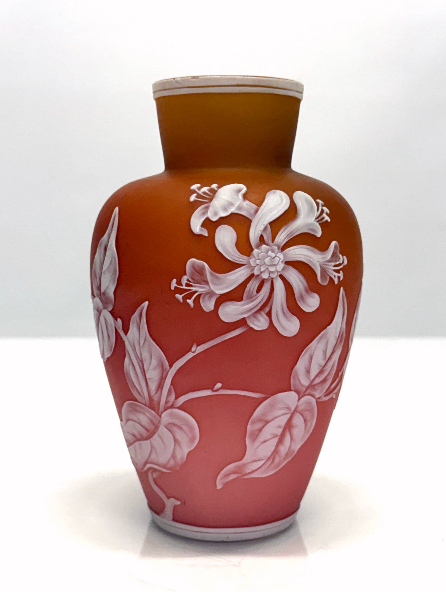 Thomas Webb Cameo Glass Vase: Thomas Webb Cameo Glass Vase Thomas Webb & Sons, circa 1880-1890. Overlaid in opaque white and transitional pink-to-orange. Finely wheel-engraved with flower blossoms. Opaque white interior. Ht. 6 1/2