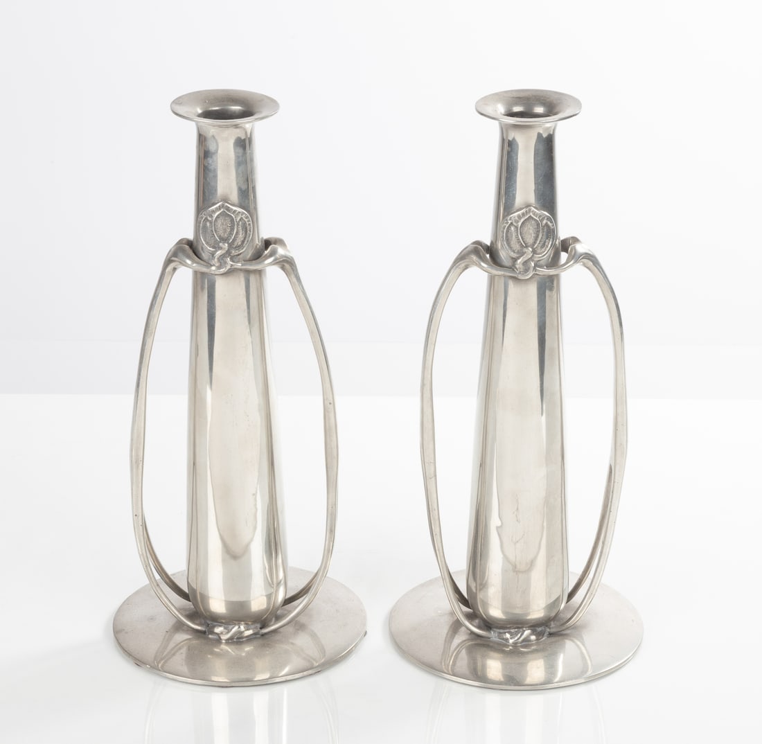 Pair of Archibald Knox (1865-1933) Tudric Twin-Handled Vases: Pair of Archibald Knox (1865-1933) Tudric Twin-Handled Vases Made for Liberty and Co., London, model no. 0212. Of tapering form, on a circular foot. Stamped 'TUDRIC 0212'. Ht. 14 in. The collection of