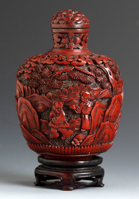 Finely Carved Cinnabar Lacquer Snuff Bottle: Finely Carved Cinnabar Lacquer Snuff Bottle . Bulbous form, carved with deep relief of garden scenes. Ht. 3 1/2".