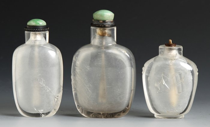 Three Rock Crystal Snuff Bottles: Three Rock Crystal Snuff Bottles. Ovate flattened flask relief carved, Ht. 2 1/2"; Round flattened flask, with yin yang, Ht. 3"; Flattened spade shaped, relief carved scrolls and Foo dogs, internal fr