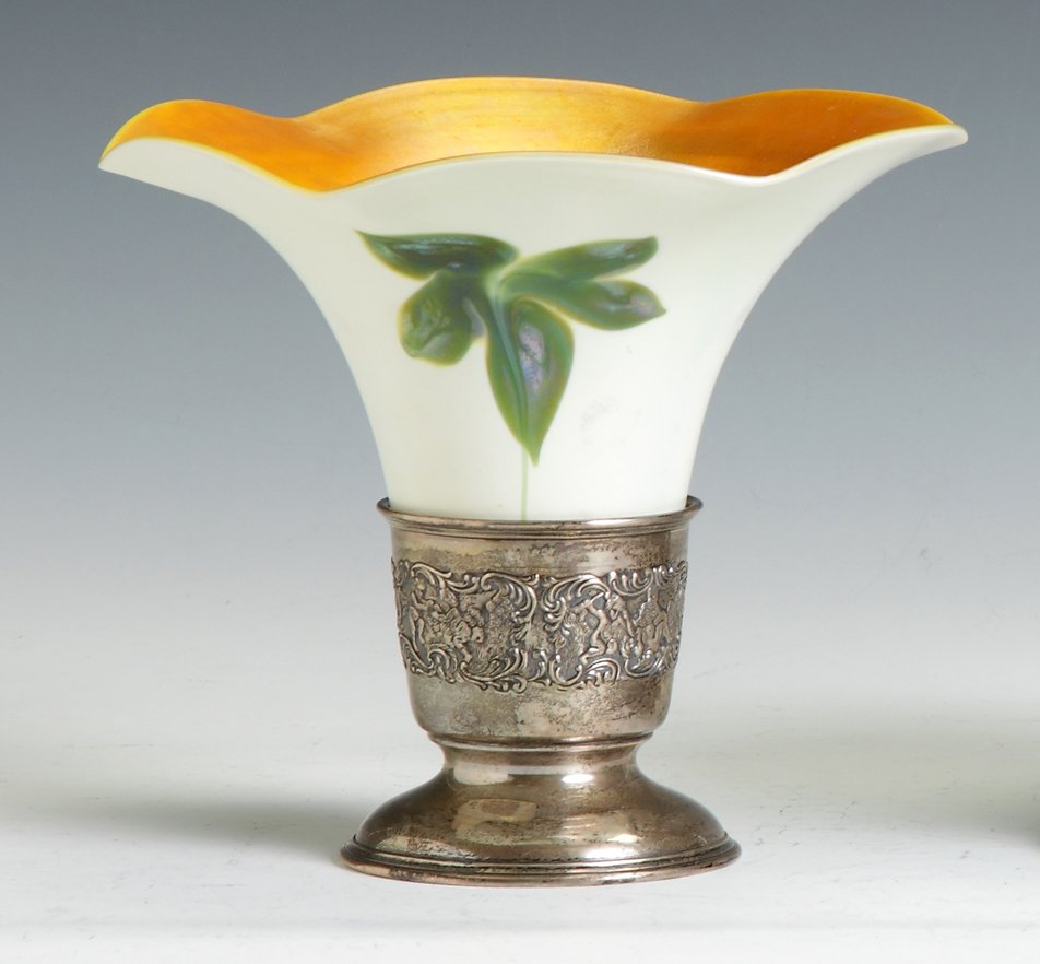 Sgn. Quezal Art Glass Vase: Sgn. Quezal Art Glass Vase. Decorated w/green flowers & gold iridescence. Sterling marked Bailey, Banks & Biddle Co. Ht. 6 3/4" Dia. 7 3/4". Dr. George & Angie Shaheen Collection, Fayetteville, NY.