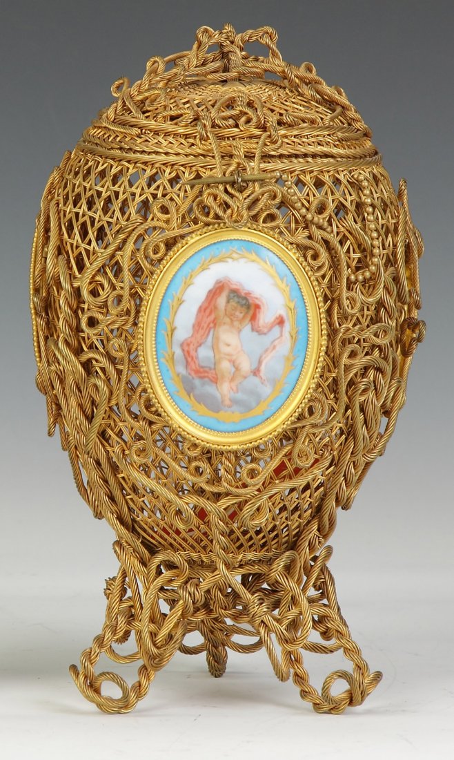 French Egg Shaped, Gilded Wire Covered Basket: French Egg Shaped, Gilded Wire Covered Basket. 19th cent. Ht. 9 1/2". Property from The Strong, sold to benefit the museum's collections fund.