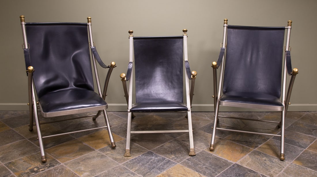 Maison Jansen Campaign Lounge Chairs: Maison Jansen Campaign Lounge Chairs France, circa 1970. Leather, brushed steel, and brass. Max 40 x 24 x 30 in. Shipping Note: We provide our own in-house shipping service; separate from LiveAuctione