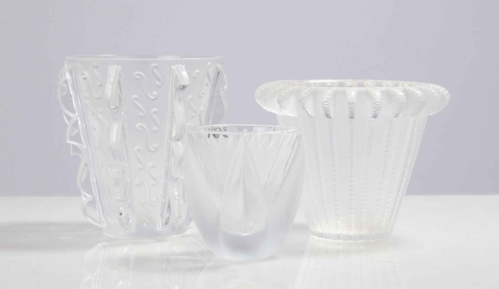 Lalique Swing Note, Royat, & Thebes Vases: Lalique Swing Note, Royat, & Thebes Vases 20th century. Molded and frosted glass. Inscribed signature 'Lalique France. Max Ht. 7 1/4 in Private collection, Buffalo, New York. Shipping Note: We provide