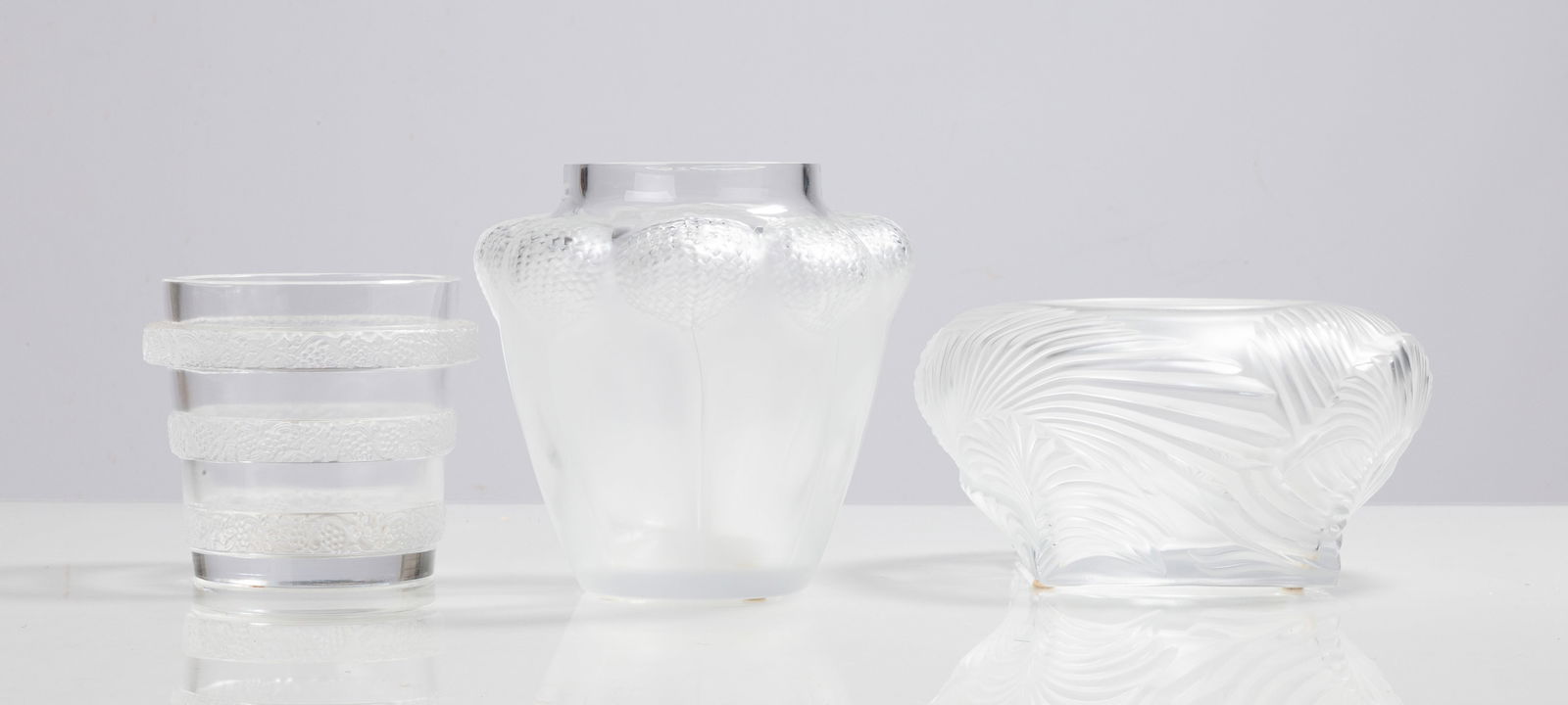Lalique Ricquewihr Lave-Raisins, Bali, & Hutan Vases: Lalique Ricquewihr Lave-Raisins, Bali, & Hutan Vases 20th century. Molded and frosted glass. Inscribed signature 'Lalique France'. Max Ht. 7 in. Private collection, Buffalo, New York. Shipping Note: W