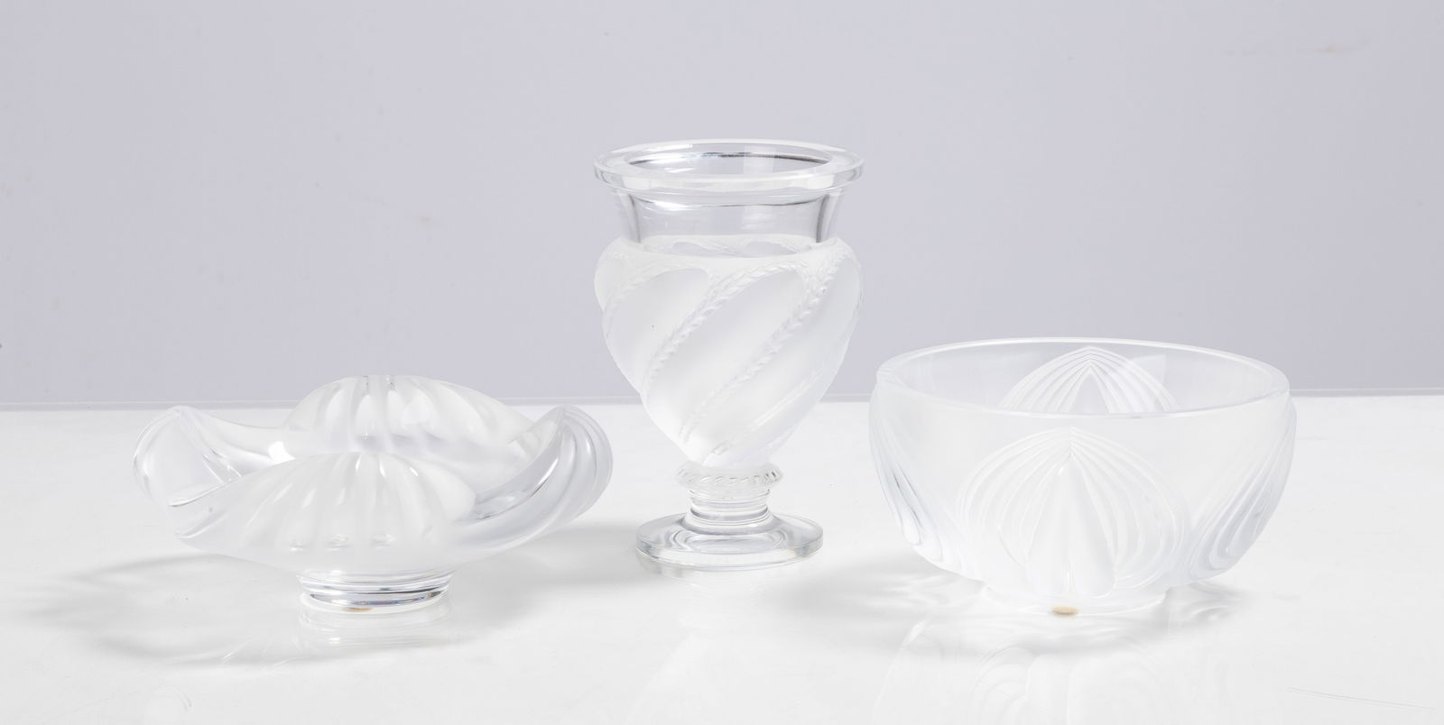 Lalique Aruba, Ermenonville, & Pinsons Vases: Lalique Aruba, Ermenonville, & Pinsons Vases 20th century. Molded and frosted glass. Inscribed signature 'Lalique France'. Max Ht. 5 3/4 in. Private collection, Buffalo, New York. Shipping Note: We pr