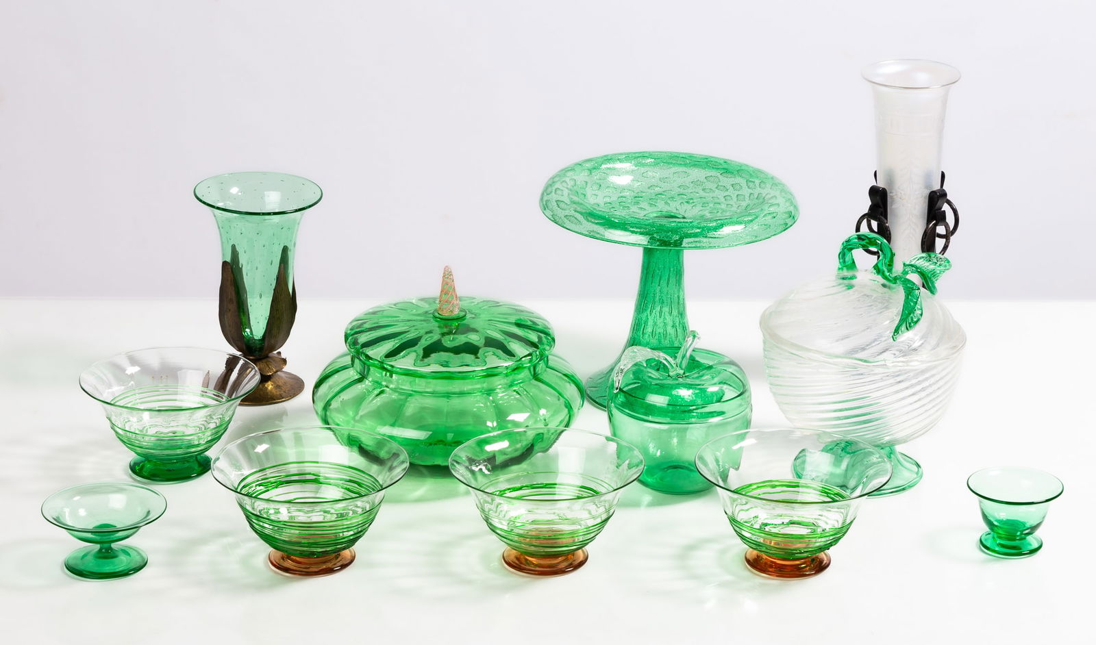 Steuben Pomona Green Tableware: Steuben Pomona Green Tableware Corning, New York, early 20th century. Blown glass. Max Ht. 9 1/2 in. The collection of Bill Mehlenbacher (1943-2023). Shipping Note: We provide our own in-house shippin