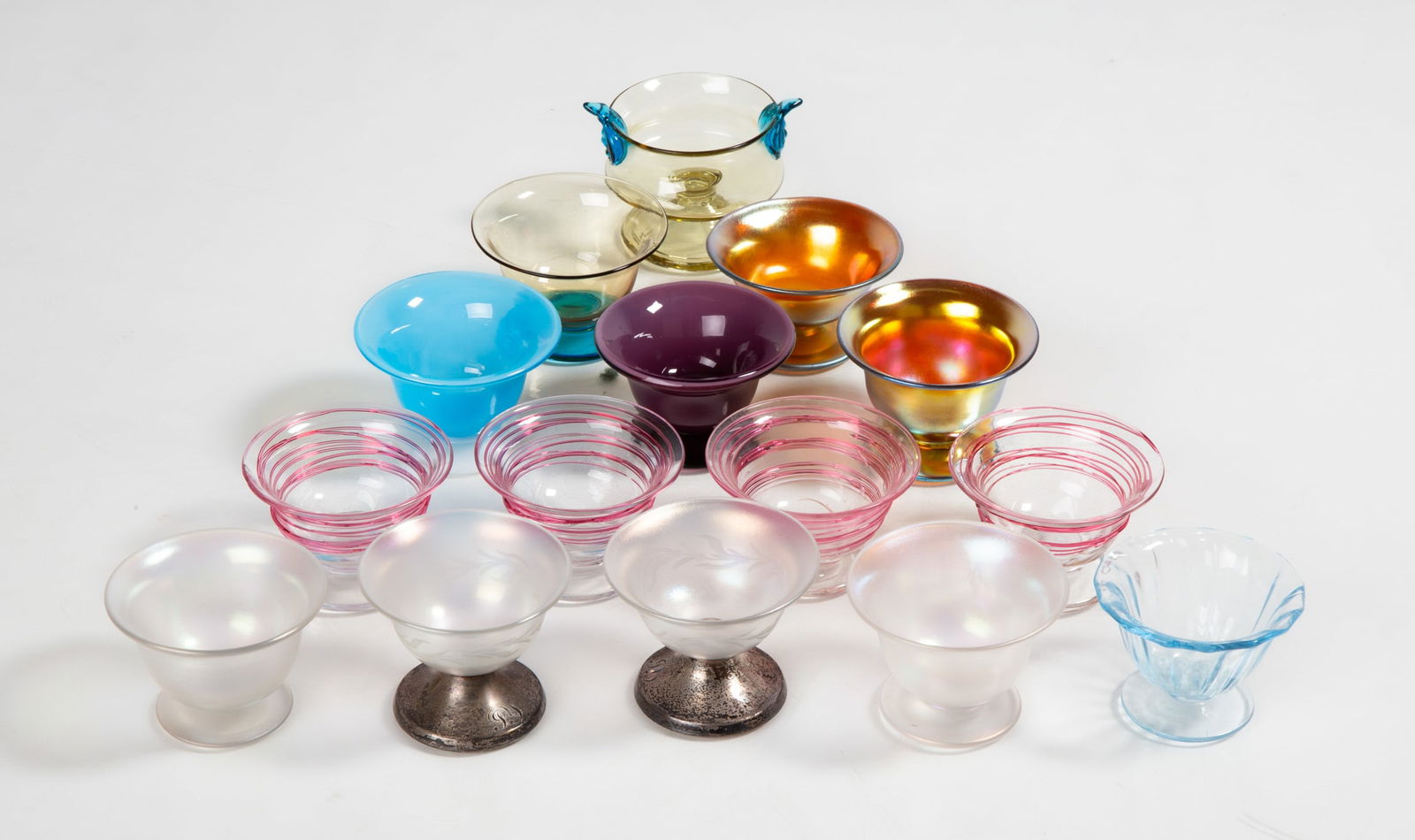 Steuben Salt Cellars: Steuben Salt Cellars Corning, New York, early 20th century. Blown glass. Including Steuben Verre De Soie iridescent glass salt cellars and Gorham sterling. Max Ht. 1 1/2 in. The collection of Bill Meh