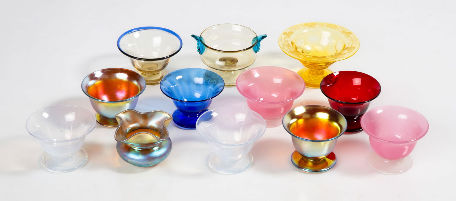 Steuben Salt Cellars: Steuben Salt Cellars Corning, New York, early 20th century. Blown glass. Max Ht. 1 1/2 in. The collection of Bill Mehlenbacher (1943-2023). Shipping Note: We provide our own in-house shipping service;