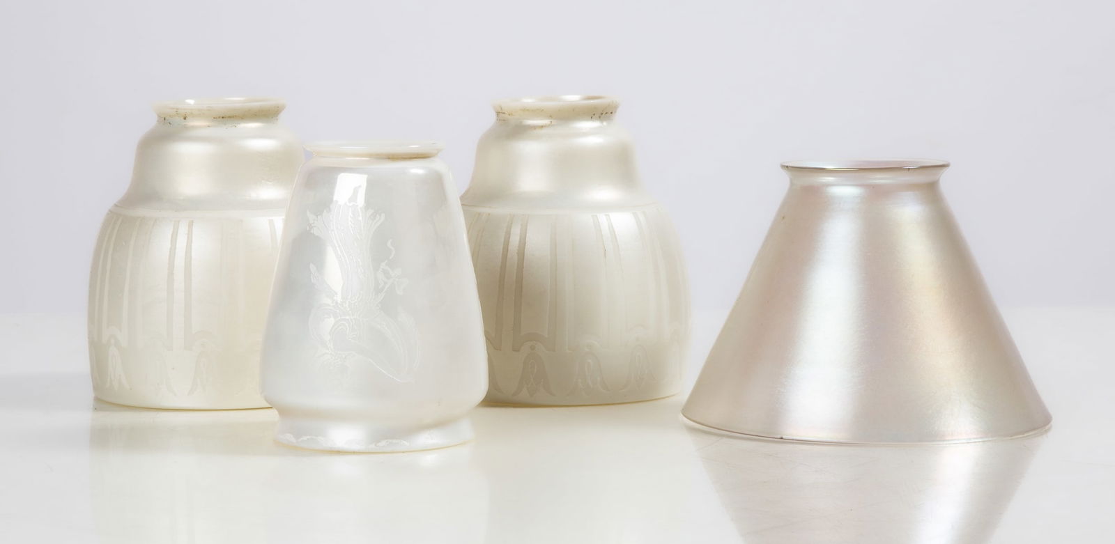 Steuben Verre de Sois Shades: Steuben Verre de Sois Shades Corning, New York, early 20th century. Blown glass. Two matched pair, with engravings. Max Ht. 5 in. The collection of Bill Mehlenbacher (1943-2023). Shipping Note: We pro