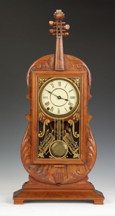 Rare Seth Thomas Violin Clock: Rare Seth Thomas Violin Clock. Walnut case with carved & applied trim, old finish. Original dial. Original painted glass. 8 day time and strike lyre movement. Nice clean label. Ht. 29".