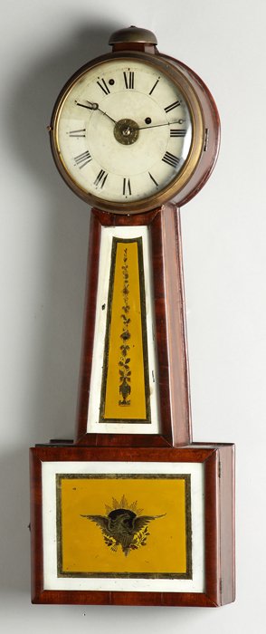 New England Banjo Clock: New England Banjo Clock. Early 19th cent. Mahogany case, old patina. Old reverse painted tablets with eagle. 8 day time only weight driven brass movement with alarm mechanism and outside bell. Ht. 29 