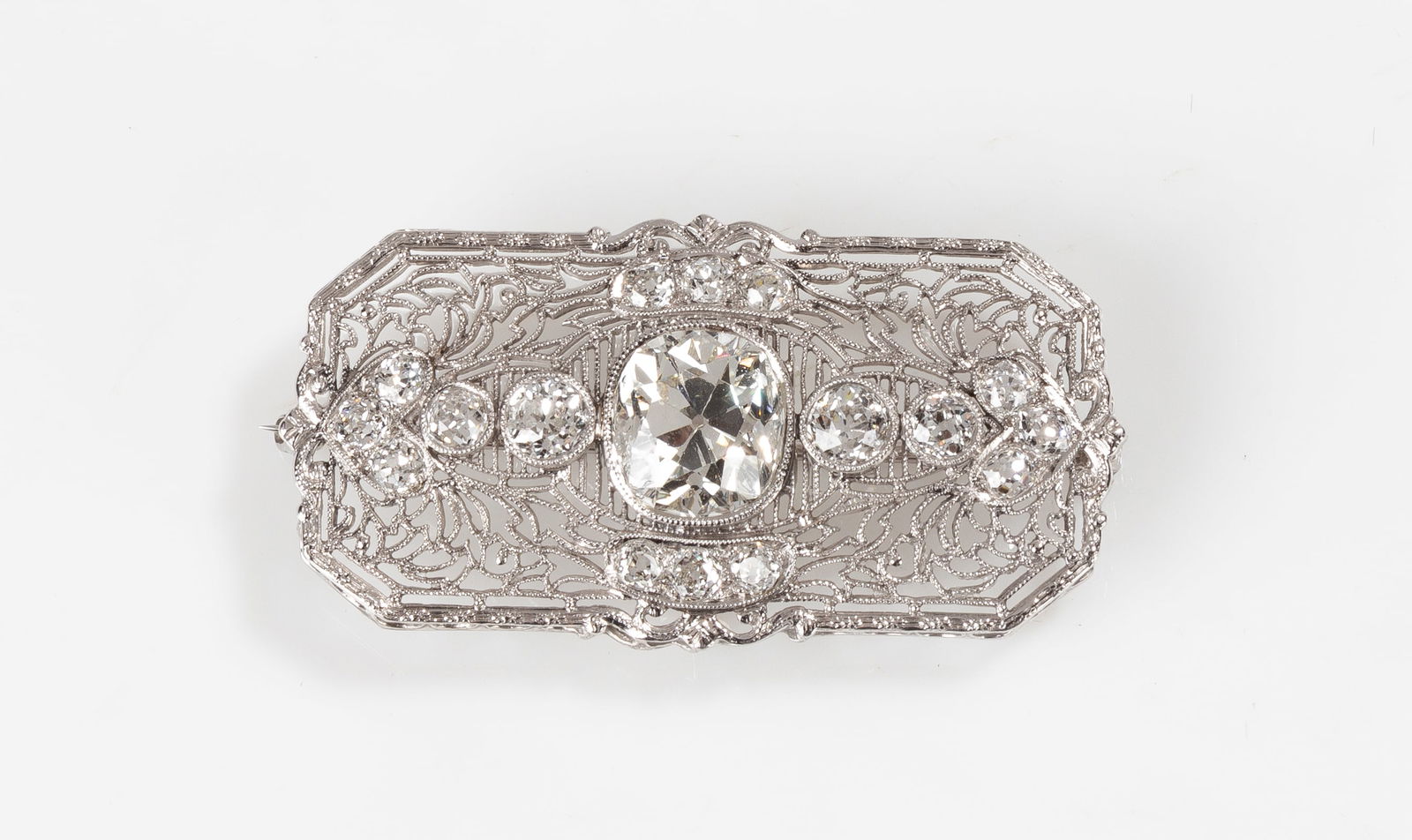 Platinum & Diamond Art Deco Filigree Brooch: Platinum & Diamond Art Deco Filigree Brooch 14K white gold and platinum. Old European cut diamond. Hallmarks of '14K & PL' on clasp. Markers mark 'K' within enclosure. L. 1 3/4 in. Shipping Note:
