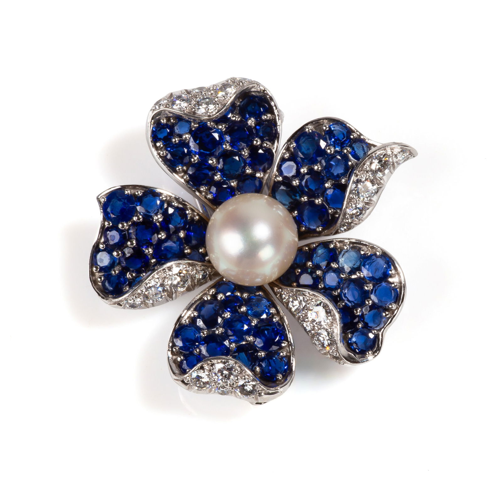 Van Cleef & Arpels Sapphire, Diamond, & Pearl "Fleur" Clip / Brooch: Van Cleef & Arpels Sapphire, Diamond, & Pearl "Fleur" Clip / Brooch Articulated petals set with round sapphires and single-cut diamonds in shared-prong settings, centered by a cultured pearl. The