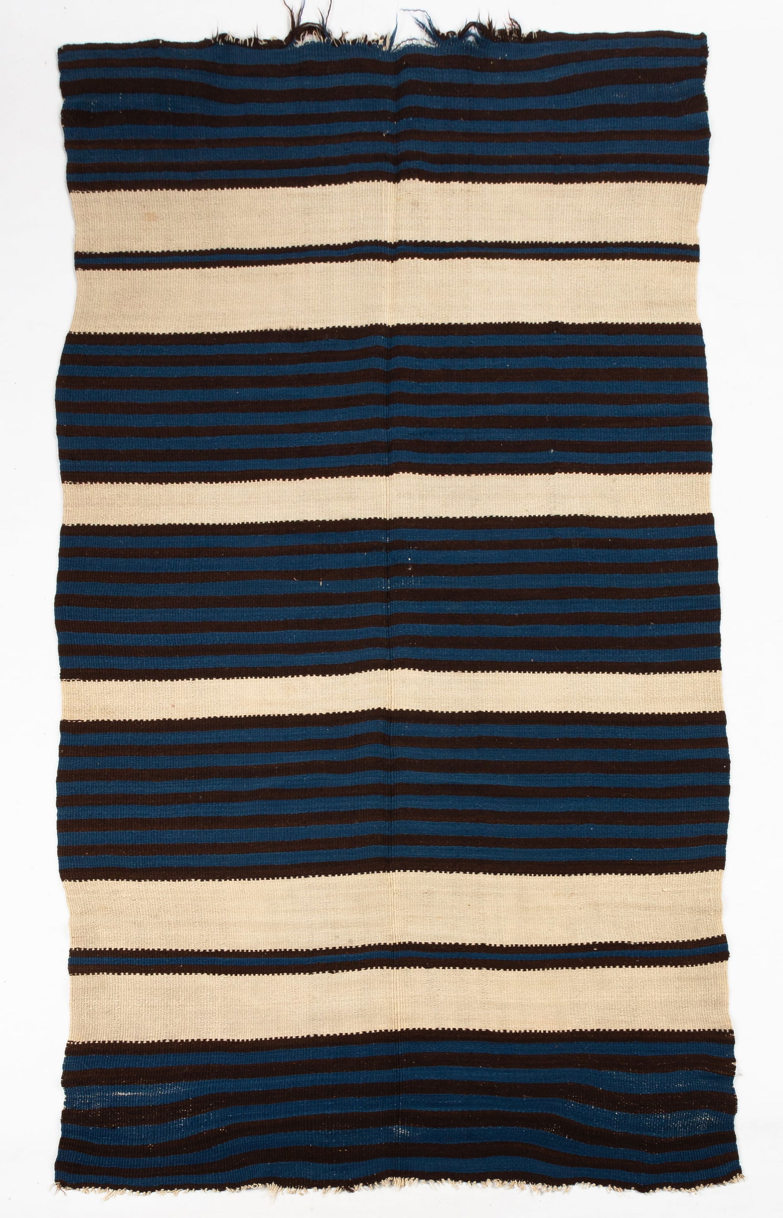 A Classic Rio Grande Blanket: A Classic Rio Grande Blanket 19th century. Cream white, natural brown, and indigo blue. 7 ft. 9 in. x 4 ft. The Charles E. Balback (1934-2024) collection, Buffalo, New York. Shipping Note: We