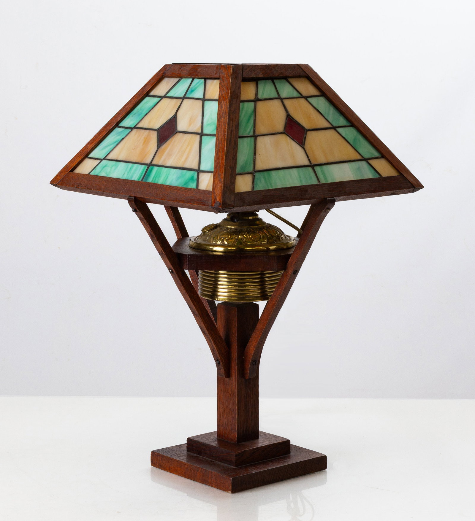 Arts & Crafts Oak and Leaded Glass Table Lamp: Arts & Crafts Oak and Leaded Glass Table Lamp Early 20th century. Oak, brass, leaded glass. Ht. 22 1/2 in. The collection of Dr. Bruce A. Austin, Pittsford, New York. Shipping Note: We provide our own