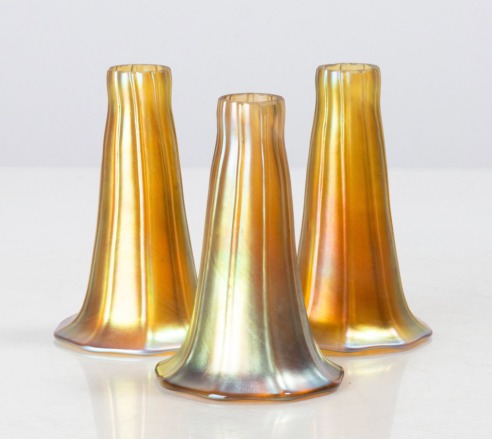 Three Art Glass Lily Shades: Three Art Glass Lily Shades 20th century. Blown glass. Comprising three shades. Ht. 5 in. Shipping Note: We provide our own in-house shipping service; separate from LiveAuctioneers. We can also help