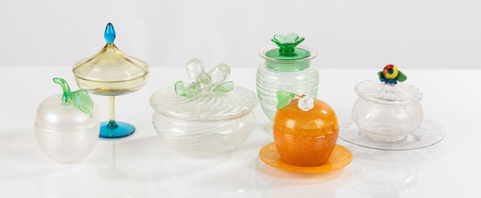 Steuben Compotes, Covered Jars, & Decanters: Steuben Compotes, Covered Jars, & Decanters Blown and mould-blown glass with applied and tooled ornament. Comprising six covered jars, two with underplates, and a covered compote. Max Ht. 7 in. The