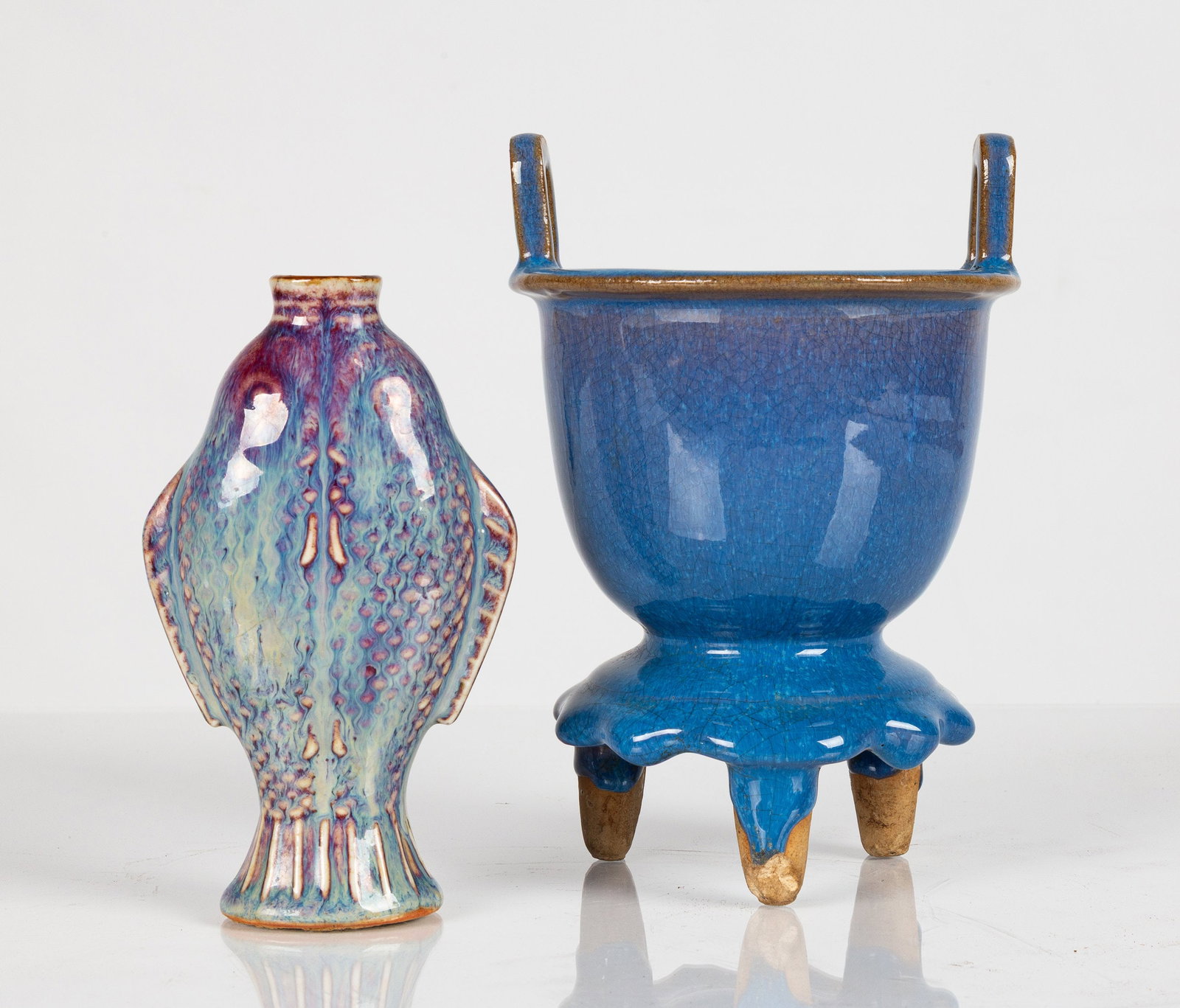 Two Chinese Flambe-Glazed Vessels: Two Chinese Flambe-Glazed Vessels China, Qing Dynasty / Republic Period. Glazed stoneware. Comprising two vessels and a separate foliate stand. The underside of the stand with two adhesive inventory