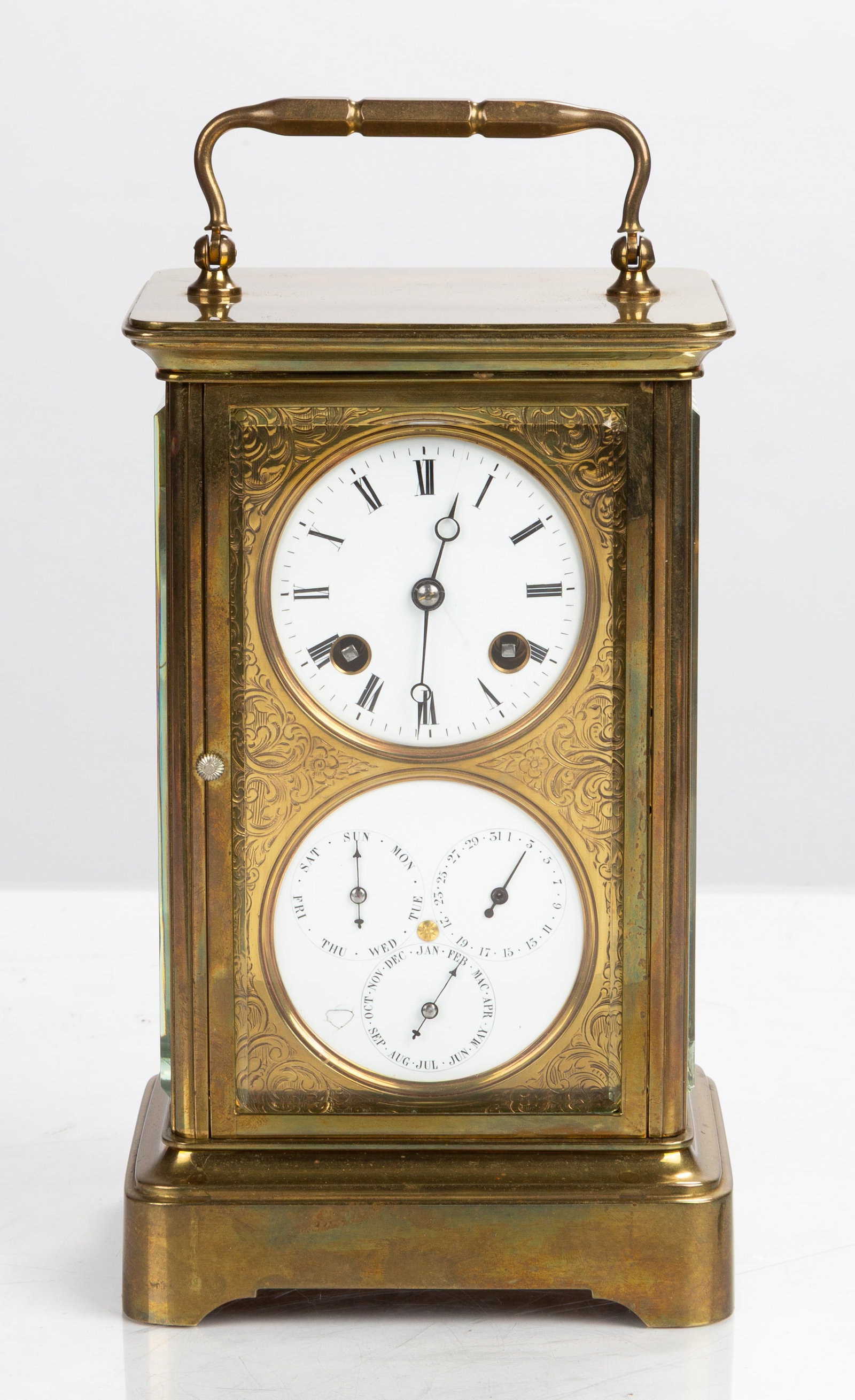 French Brass Carriage Clock with Calendar, Japy Freres: French Brass Carriage Clock with Calendar, Japy Freres Late 19th century. Brass case with beveled glass panels and hinged handle. White enamel dial above a calendar dial for day, date and month, in an