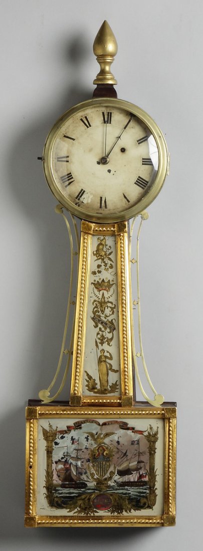 Gilt Front Banjo: Gilt Front Banjo. Dial marked Jones. Appears to retain original tablets, "Capture of the Frolic". 8 day time only weight driven brass movement. Ht. 34"
