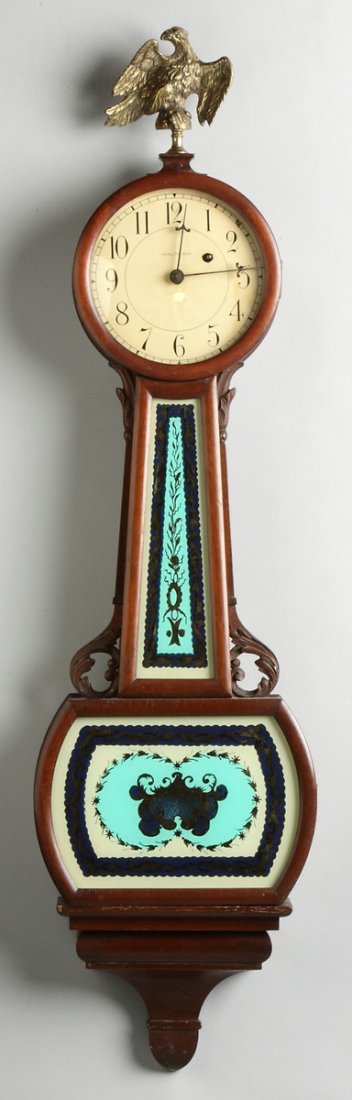 Waltham Banjo: Waltham Banjo. Mahogany case. Reverse painted tablets. 8 day time only weight driven brass movement. Ht. 41"