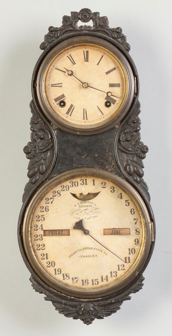 Ithaca Iron Front Wall Clock: Ithaca Iron Front Wall Clock. Painted cast iron case. Original painted paper dials. 8 day time only spring driven calendar movement. Ht. 21".