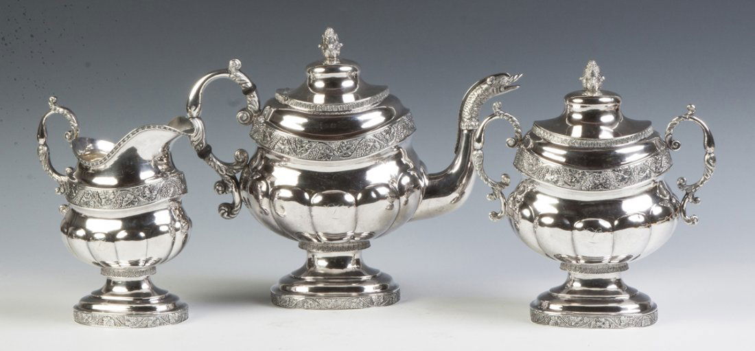 Peter Chitry (American) Three Piece Coin Silver Tea Set: Peter Chitry (American) Three Piece Coin Silver Tea Set. C. 1820. Lobed body with hand chased grape & leaf border. Serpent spout, acorn finials. Monogrammed. 68 ozt. Max. Ht. 10".