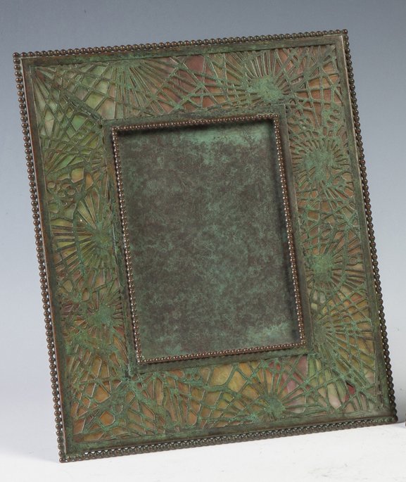 Tiffany Studios Bronze Frame - Pine Needle: Tiffany Studios Bronze Frame - Pine Needle . Sgn. Tiffany Studios New York. Reddish green glass. Ht. 9 1/2" W 8". Richard Bright and Kyle Goodman Collection, Corning, NY.