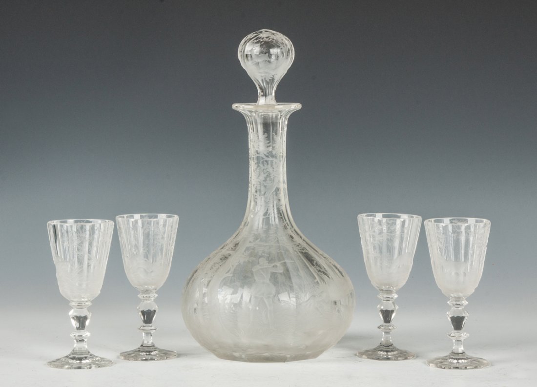 Engraved Glass Decanter Set: Engraved Glass Decanter Set Hunters and hunting scene on decanter; animals on glasses. Together with 4 Baccarat cut glass cordials, one has nick to top. Small nick to stopper, a few small chips, other