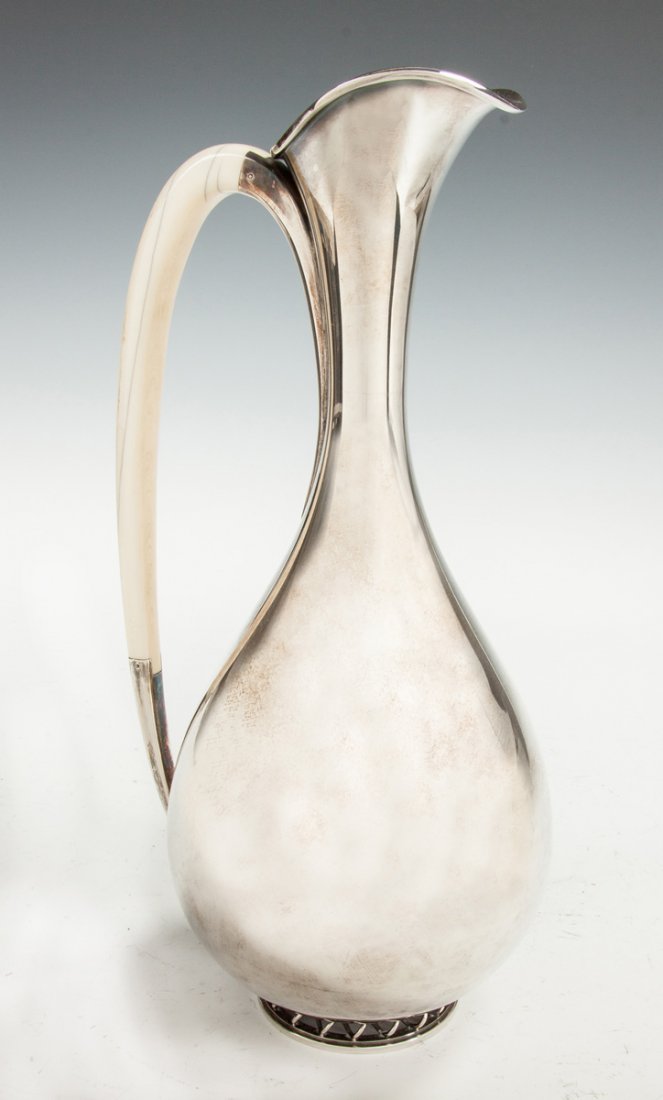 Frantz Hingelberg (Danish) Sterling Silver Ewer: Frantz Hingelberg (Danish) Sterling Silver Ewer. Mid 20th cent. Sgn. F. Hingelberg, Aarhus, 925S. Designed by Svend Weihrauch. Bone handle, raised wire base. 21.9 ozt. Ht. 11".