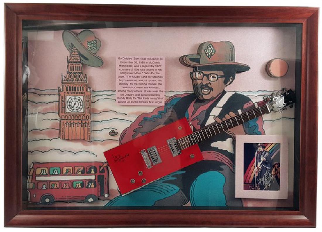 Bo Diddley Signed Guitar Framed: "Bo Diddley" framed and autographed "Gretsch" cherry red guitar and picture. Framed in a wooden case with a plexiglass display. Certification included. Measures approximately 42" x 60".