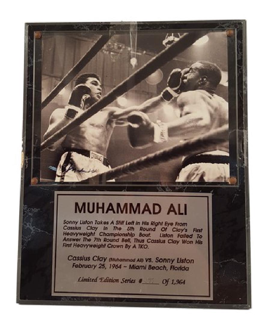 Muhammad Ali Signed Photo Plaque of Sonny Liston &: "Muhammad Ali" autographed photograph plaque of "Sonny Liston taking a stiff left in his right eye from Cassius Clay in the 6th round of Clay's first heavyweight championship bout. Liston failed to an