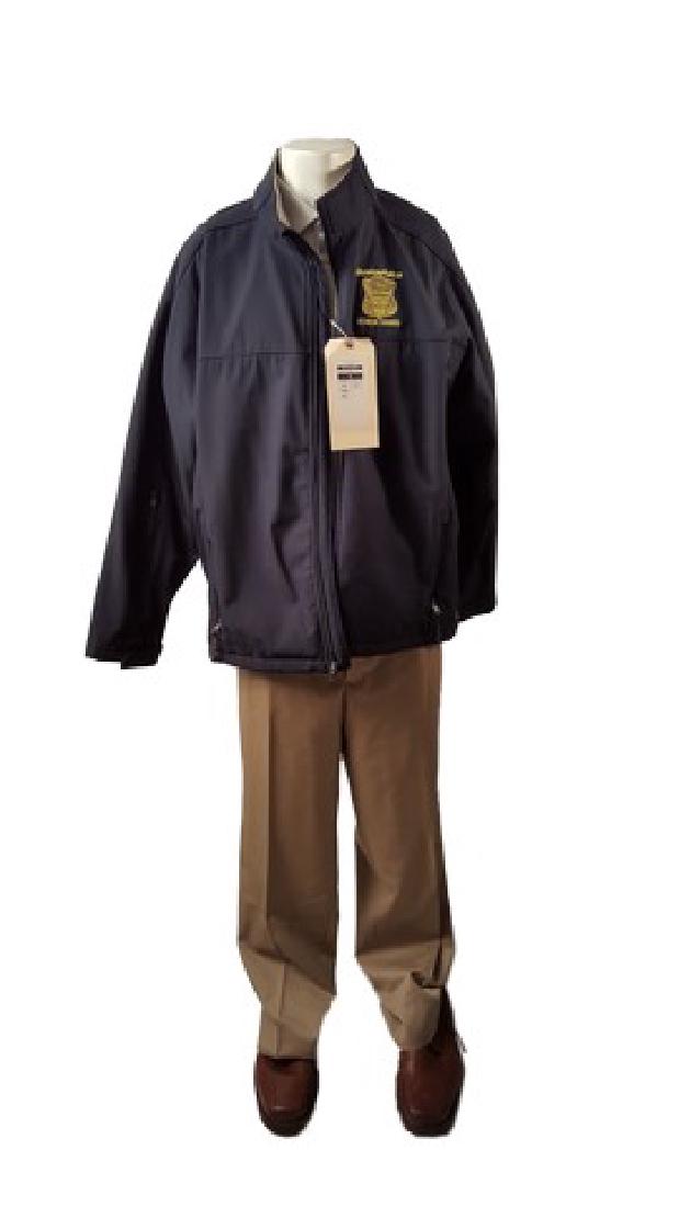 Patriots Day Ed Davis (John Goodman) Movie Costumes: Straight from the CBS Films Patriots Day is Ed Davis (John Goodman) screen worn, navy blue "Charles Rivers" front zip fleece that has a gold embroidered 'Boston Police honor guard' badge on the left c