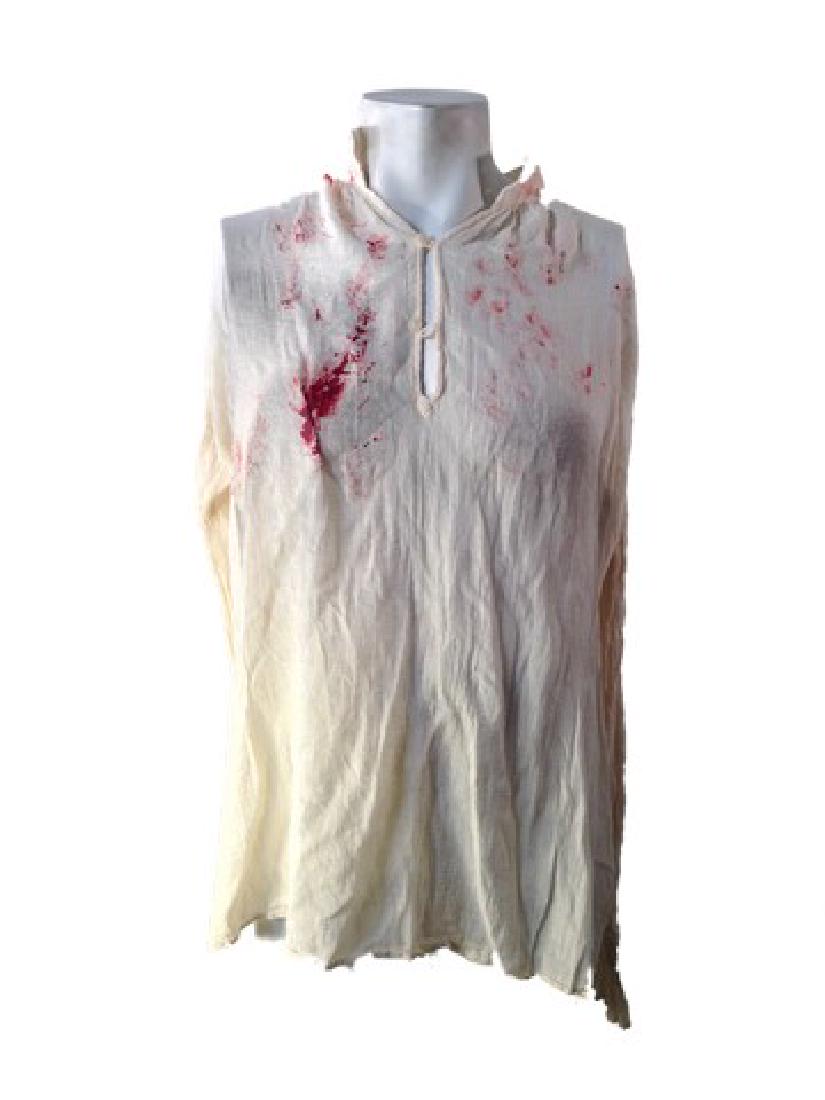 The Patriot Benjamin (Mel Gibson) Movie Costumes: The Patriot (2000)- From the dramatic feature film comes Benjamin's (Mel Gibson) screen worn, hero bloody off white tunic. This is heavily production distressed and soiled with production blood.