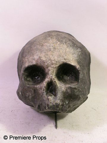 Angels and Demons Black Skull Movie Props: Angels and Demons - From the set of Angels and Demons, this is a black painted hard foam with a screw going through the middle skull. (approx. 5 1/2" x 5") (EA2001)