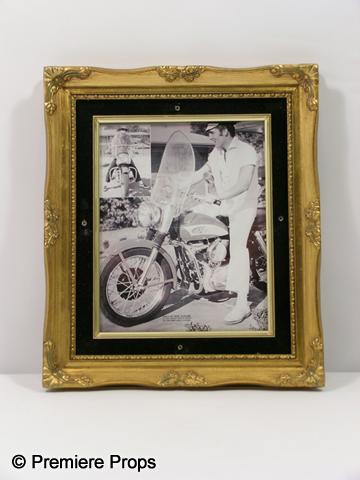 Elvis Presley Framed Photo: Elvis Presley black and white photo of him riding a motorcycle framed in a gold color wood frame. (approx. 14 1/2" x 12 1/2")