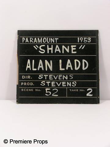 "Shane" Clap Board Sign: Black and white non functioning wood clap board style sign featuring Alan Ladd "Shane" in "Shane" (1953). (approx. 13 1/2" x 12")