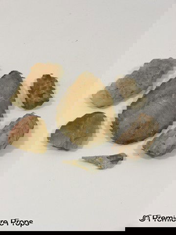 The Road Old Tools Movie Props: The Road - Set of six fossil hominid tools including an Acheulian Banded Flint Hand Axe from South West Morocco, a Mousterian Neanderthal Triangular Bi-facial Hand-Axe, a Mousterian Bifacial ovate poi