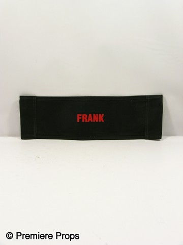 Red Frank (Bruce Willis) Chair back Movie Props: Red - Black chair back with 'Red' logo in red on one side and Frank (Bruce Willis) on the other. (approx. 22" x 7")