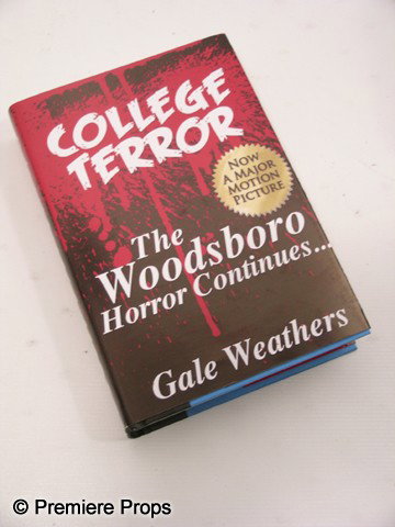 Scream 4 Gale Weathers-Riley (Courteney Cox) Movie: Scream 4 - Gale Weathers-Riley (Courteney Cox) screen used, 'College Terror The Woodsboro Horror Continues…' hardcover book cover with a real 'The Gates of Heaven' book under. (approx. 9 1/2" x 6 1/