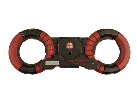 Resident Evil: The Final Chapter Umbrella Corp LED Handcuffs Movie Props: Umbrella Corporation screen used manacles(handcuffs) with Umbrella Corporation symbol and LED. (Non-functioning hard plastic cuffs) (Approx. 12" x 5")