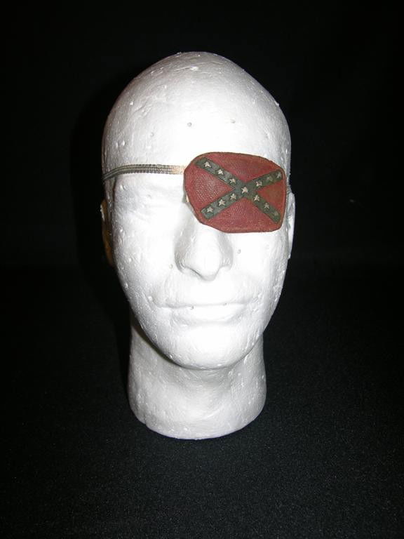 Robert Englund Eyepatch from 2001 Maniacs: Confederate eyepatch used by actor Robert Englund in 2001 Maniacs, Tim Sullivan's re-imagining of Herschell Gordon Lewis' seminal gore film 2000 Maniacs. This screen-used eyepatch features a fully pai