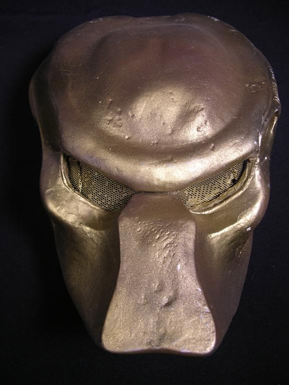 Predator Helmet Casting: Predator helmet casting, taken from a production made helmet used in one of the later Predator films. This helmet is painted gold and features screened eye aperatures. (19x11x9)