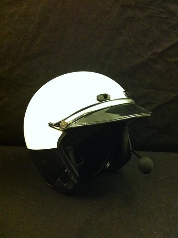 Terminator 2 Motorcycle Helmet: Terminator 2 screen used white motorcycle police helmet, similar in style to the one worn by T-1000 in the film. This helmet features an attached, hands-free microphone and has had its police shield d
