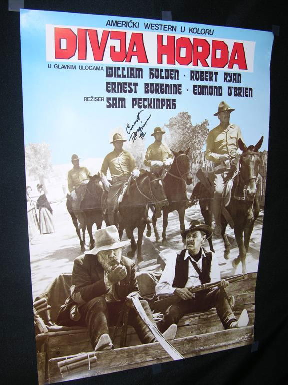 The Wild Bunch Signed Poster: Original issue Yugoslavian movie poster for The Wild Bunch, Sam Peckinpah's iconic Western classic. This poster has been signed in black felt pen by co-star Ernest Borgnine. (27x19)