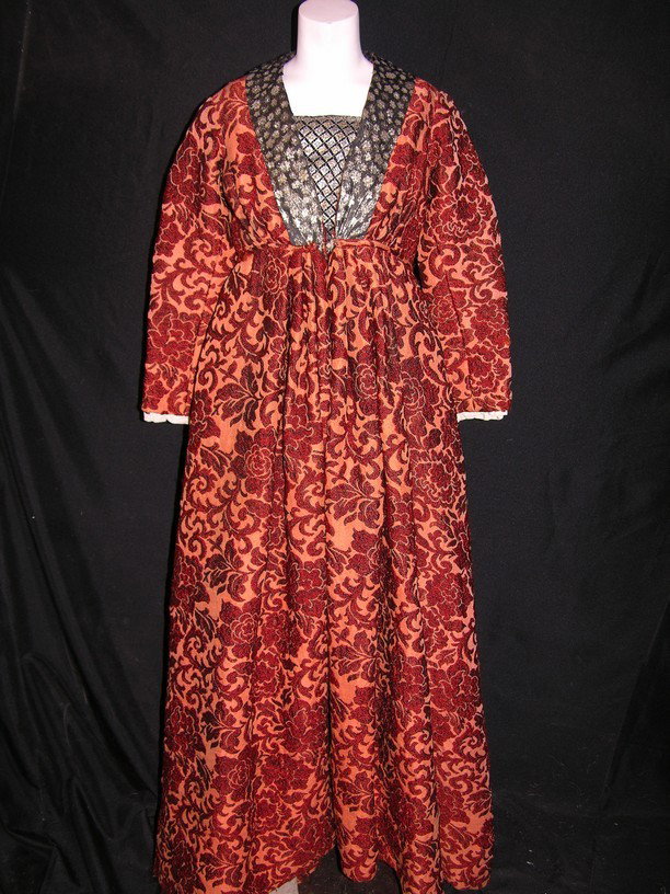 Screen Worn Star Trek: Deep Space Nine Costume: Elaborate, very heavy orange dress with floral motif, worn by an actress on the television series Star Trek: Deep Space Nine. The dress is in a demi-medieval style and was most likely used in one of t